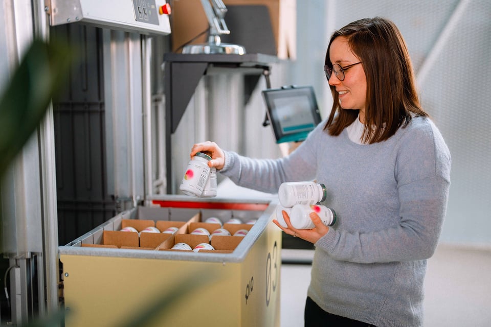 Warehouse worker managing high-volume orders using scalable automation instead of seasonal hires.